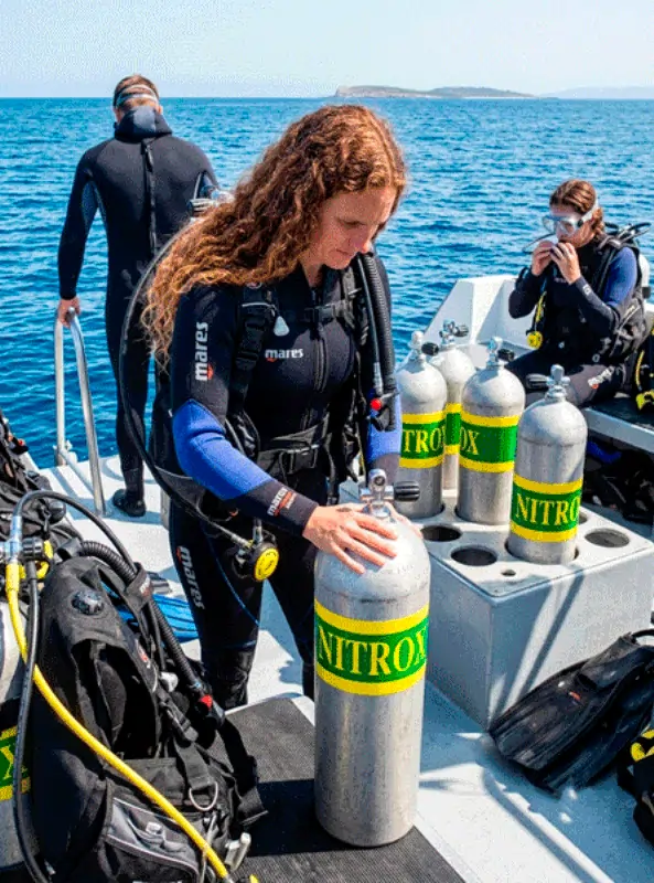 Dive instructor and diver checking gear before a Nitrox dive