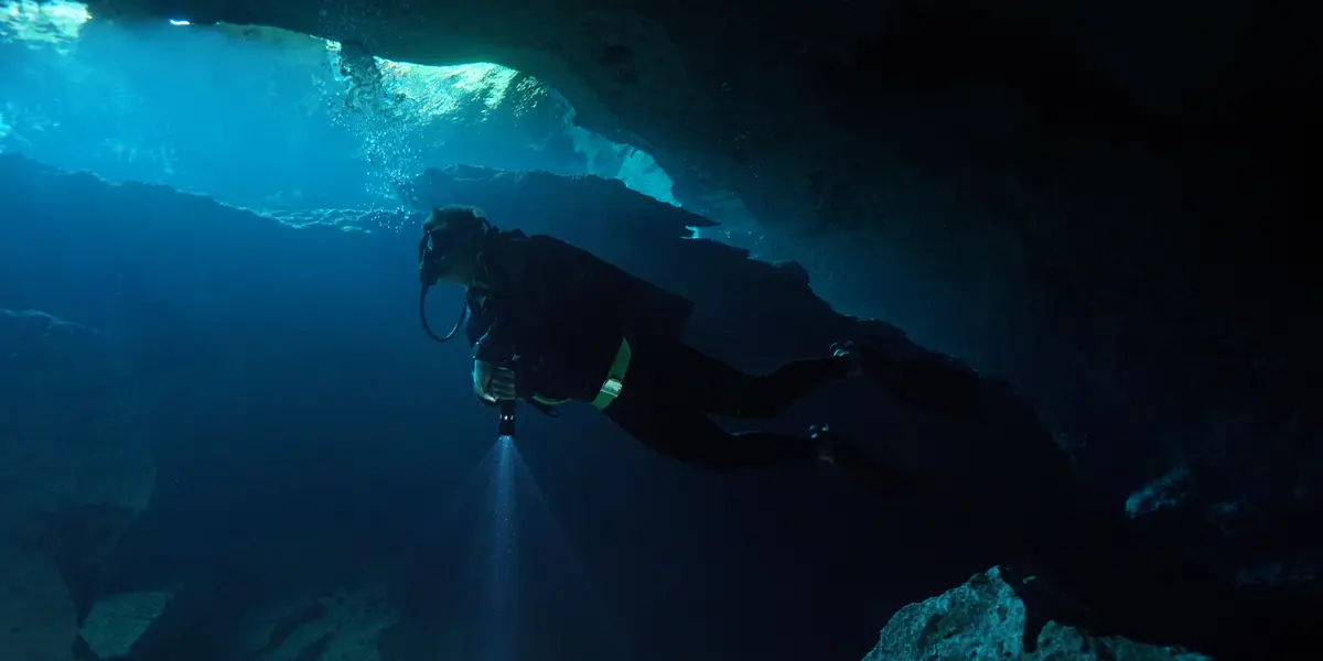 Certified diver under natural cavern light at Cenote Chikin Ha