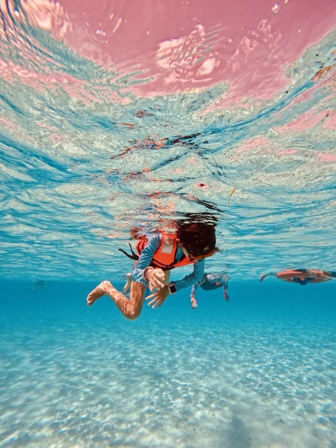 Girl swimming underwater during a snorkeling tour in Playa del Carmen